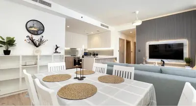 a living room with a table and a blue couch at Burj Khalifa and Canal view 2 BDR Apartment in Dubai