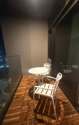 two white chairs and a table and a table and chairs at Burj Khalifa and Canal view 2 BDR Apartment in Dubai