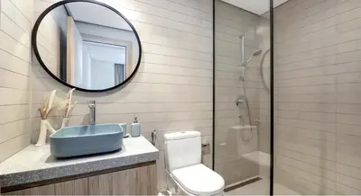a bathroom with a sink and a mirror and a toilet at Burj Khalifa and Canal view 2 BDR Apartment in Dubai