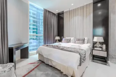 a bedroom with a large bed and a large window at TRPS - Uppercrest, Downtown - Burj Khalifa View, Furnished, Near Dubai Mall in Dubai