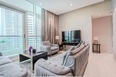 a living room with two couches and a television at TRPS - Uppercrest, Downtown - Burj Khalifa View, Furnished, Near Dubai Mall in Dubai