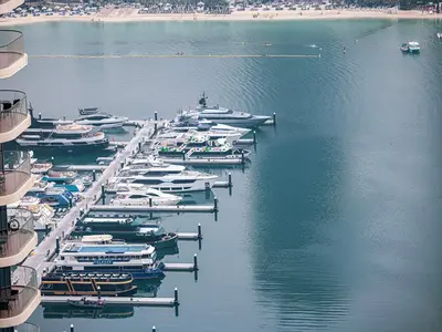 a group of boats docked in a harbor at Livin' Holidays - 1 BR - Stunning Private beach in Dubai