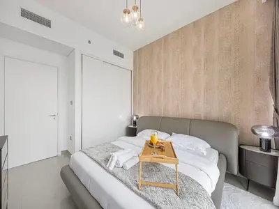 a bedroom with a bed with a table on it at Livin' Holidays - 1 BR - Stunning Private beach in Dubai