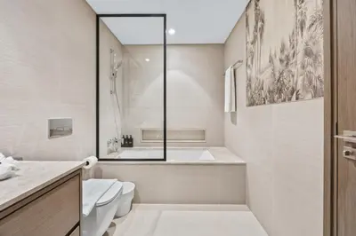 a bathroom with a tub and a toilet and a sink at Versace 1BR Downtown Burj View From Infinity Pool in Dubai