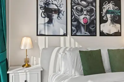 a bedroom with four pictures on the wall at Versace 1BR Downtown Burj View From Infinity Pool in Dubai