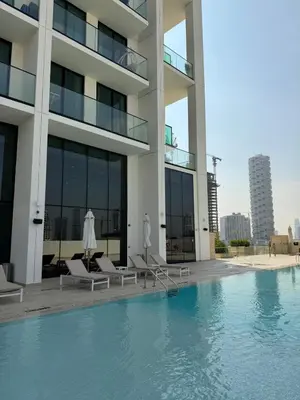 a view of a building with a swimming pool at High floor luxury apartment JVC in Dubai