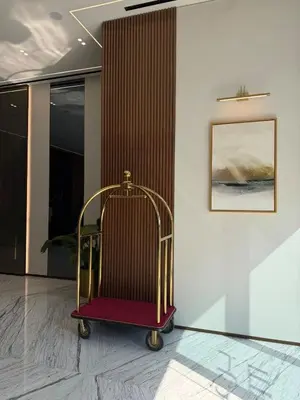 a luggage cart in a room with a wall at High floor luxury apartment JVC in Dubai