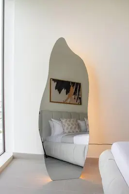 a bed in a room with a mirror at Cozy 2BR Apartment in Dubai Hills with Cinema and Lounge Access in Dubai
