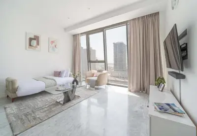 a white living room with a bed and a large window at Test Property - NoBookings in Dubai