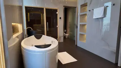 a bathroom with a white toilet and a shower at Signature Palm Villa Exclusive 6 BDR Retreat in Dubai