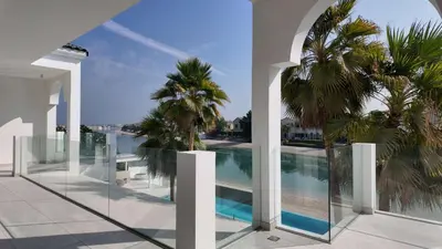a view of a swimming pool from a building with palm trees at Signature Palm Villa Exclusive 6 BDR Retreat in Dubai