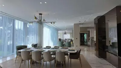 a dining room with a table and chairs at Signature Palm Villa Exclusive 6 BDR Retreat in Dubai
