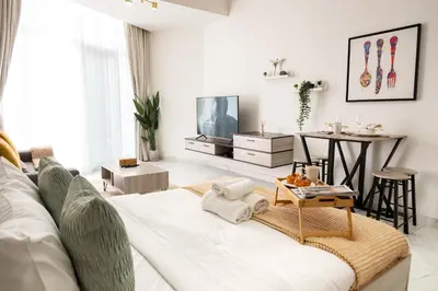a living room with a couch and a table at Stylish Apartment with Swimming Pool Near Dubai Mall and Burj Khalifa in Dubai