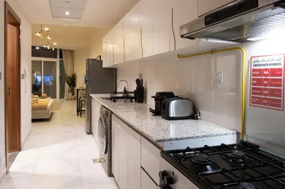 a kitchen with a stove and a counter top at Stylish Apartment with Swimming Pool Near Dubai Mall and Burj Khalifa in Dubai