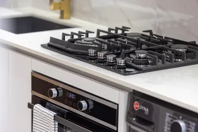 a black stove top oven in a kitchen at Restay Homes at Binghatti Azure - Great City Escape - Swimming Pool Access in Dubai