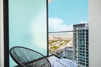 a balcony with a chair and a view of a city at Restay Homes at Binghatti Azure - Great City Escape - Swimming Pool Access in Dubai