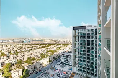 an aerial view of a city with a tall building at Restay Homes at Binghatti Azure - Great City Escape - Swimming Pool Access in Dubai