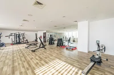 a gym with treadmills and machines in a room at Community View 1BR, Perfect Location Near Miracle Garden, Butterfly Garden and Community Spaces, Orion Building, Arjan by Deluxe Holiday Homes in Dubai