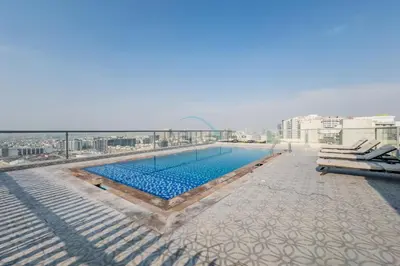 a swimming pool on the roof of a building at Community View 1BR, Perfect Location Near Miracle Garden, Butterfly Garden and Community Spaces, Orion Building, Arjan by Deluxe Holiday Homes in Dubai
