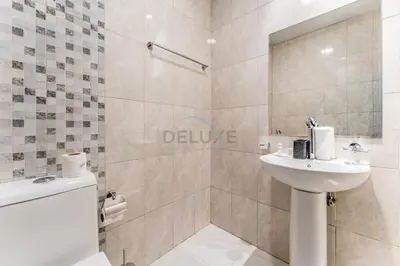 a bathroom with a sink and a toilet and a shower at Community View 1BR, Perfect Location Near Miracle Garden, Butterfly Garden and Community Spaces, Orion Building, Arjan by Deluxe Holiday Homes in Dubai