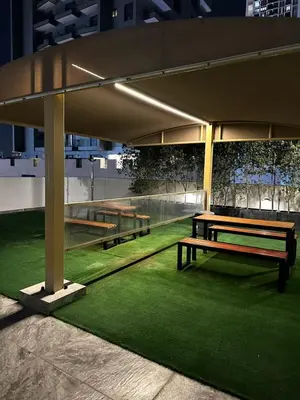 a group of benches under a pavilion at night at Modern Studio Apartment with Balcony in JVC in Dubai