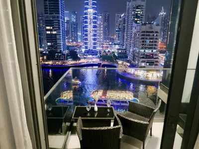 a room with a view of a city at night at Full Dubai Marina View 2BR Apartment in Dubai