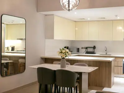 a kitchen with a table and chairs and a mirror at Full Dubai Marina View 2BR Apartment in Dubai
