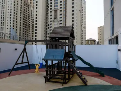a playground on the roof of a building with a swing at Full Dubai Marina View 2BR Apartment in Dubai
