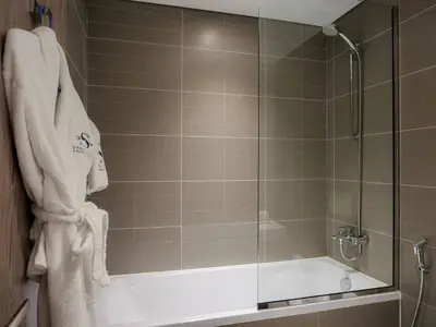 a bathroom with a shower with a tub and a glass door at Full Dubai Marina View 2BR Apartment in Dubai