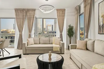 a living room with a couch and a table at Stunning 2BR with Burj Lake View at The Residences in Dubai