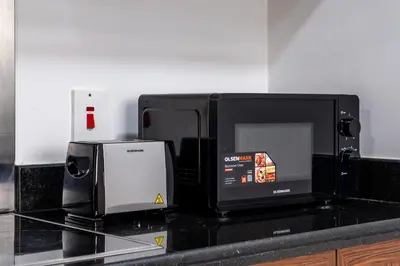a microwave sitting on top of a kitchen counter at Stunning 2BR with Burj Lake View at The Residences in Dubai