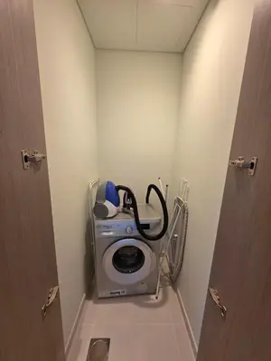 a bathroom with a washing machine in a room at 2BR next to Dubai mall with Khalifa Tower view! in Dubai