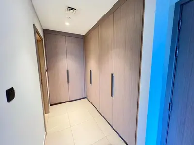a hallway with two lockers and a room with a door at 2BR next to Dubai mall with Khalifa Tower view! in Dubai