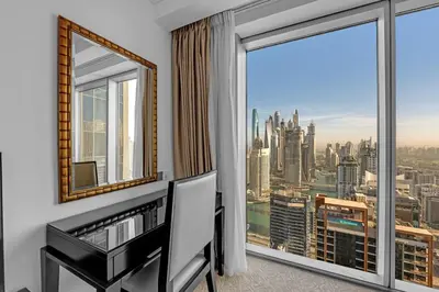 a room with a desk and a large window at Waves - Modern Comfort 1BR Apt at JW Marriott Marina Mall in Dubai
