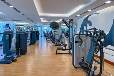 a gym with treadmills and machines in a room at Waves - Modern Comfort 1BR Apt at JW Marriott Marina Mall in Dubai