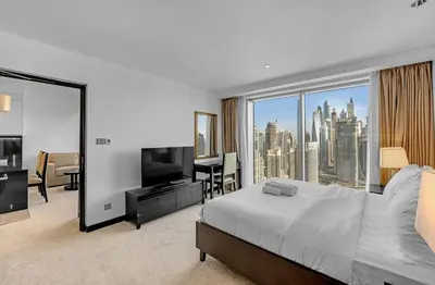 a bedroom with a large bed and a large window at Waves - Modern Comfort 1BR Apt at JW Marriott Marina Mall in Dubai