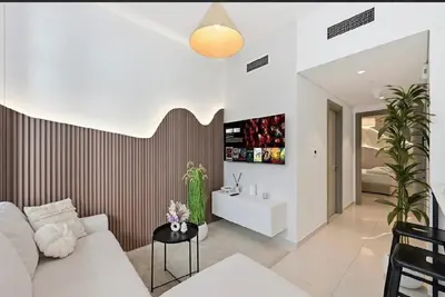 a living room with a couch and a table at Modern Flat close to Burj Khalifa with stunning pool in Dubai