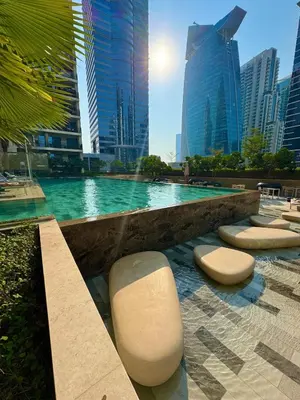 a swimming pool in a city with tall buildings at Modern Flat close to Burj Khalifa with stunning pool in Dubai