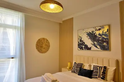 a bedroom with a bed and a painting on the wall at Luxury 2BR Private Beach Partial Sea View in Dubai