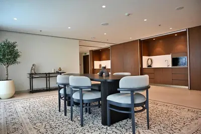 a dining room with a table and chairs at Luxury 2BR Private Beach Partial Sea View in Dubai