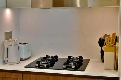 a kitchen counter with a stove top in a kitchen at Luxury 2BR Private Beach Partial Sea View in Dubai