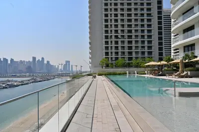 a swimming pool in the middle of a city with buildings at Luxury 2BR Private Beach Partial Sea View in Dubai
