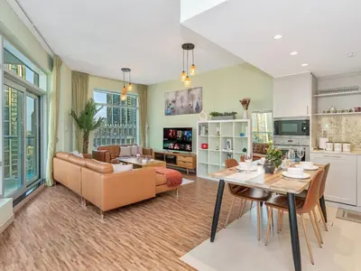 a living room with a couch and a table at 2BR Panoramic City - Burj and Fountain View in Dubai