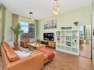 a living room with a couch and a table at 2BR Panoramic City - Burj and Fountain View in Dubai