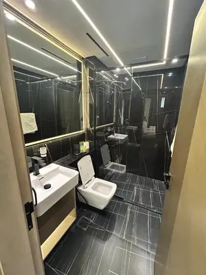 a bathroom with a toilet and a sink at Chic 1bhk Smart Apartment, near circle Mall in Dubai