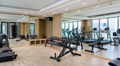 a gym with treadmills and ellipticals in a building at Chic 1bhk Smart Apartment, near circle Mall in Dubai