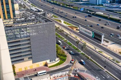 an overhead view of a highway with a tall building at Modern Studio with Skyline Views in Dubai Marina in Dubai