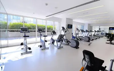 a gym with treadmills and cardio equipment in a building at Modern Studio with Skyline Views in Dubai Marina in Dubai