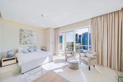a bedroom with a bed and a large window at Modern Studio with Skyline Views in Dubai Marina in Dubai