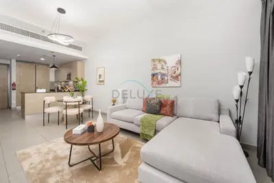 a living room with a couch and a table at Easy access to Community Parks and Green Spaces,15 minutes drive to Miracle Garden - Rigel, JVC, by Deluxe Holiday Homes in Dubai